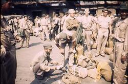 自分の荷物をさがすオランダ兵 / Dutch Soldier Searching for His Luggage image