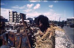 焼け跡で、ワラで体を包んだ男性 1 / Man Wrapped in Straw at the Burnt Ruins 1 image