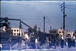 大通りで重機械を見つめる人々 / People Staring at Heavy Machinery on the Main Street image