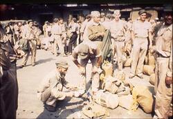 自分の荷物をさがすオランダ兵 / Dutch Soldier Searching for His Luggage image
