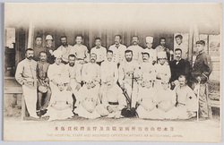 日本松山収容所病室職員及俘虜将校負傷者 THE HOSPITAL STAFF AND WOUNDED OFFICER-CAPTIVES AT MATSUYAMA, JAPAN. / Medical Ward Staff and Wounded Captive Officers in the Prisoner-of-War Camp, Matsuyama, Japan image