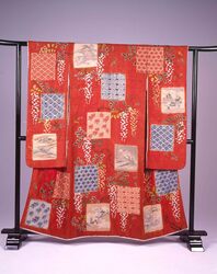 緋綸子地藤花十二ケ月色紙文様染繍絞振袖 / Scarlet Figured Satin Furisode Kimono with Wisteria Flowers and Poem Papers of the Twelve Months in Simple-Stitch Shaped Resist (Shibori) image