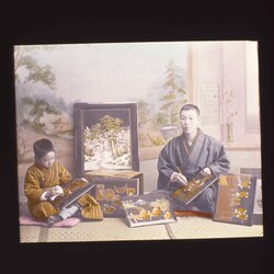 細工絵を仕上げる男性と男児 / Man and Boy Putting the Finishing Touches on Inlaid Pictures image