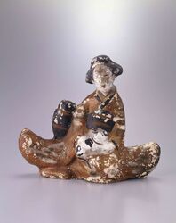 泥人形 犬を抱く女性 / Mud Doll: Woman Holding a Dog image