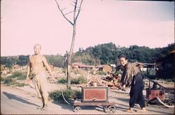 消防ポンプを運ぶ夫婦 / A Couple Carrying a Fire Pump image
